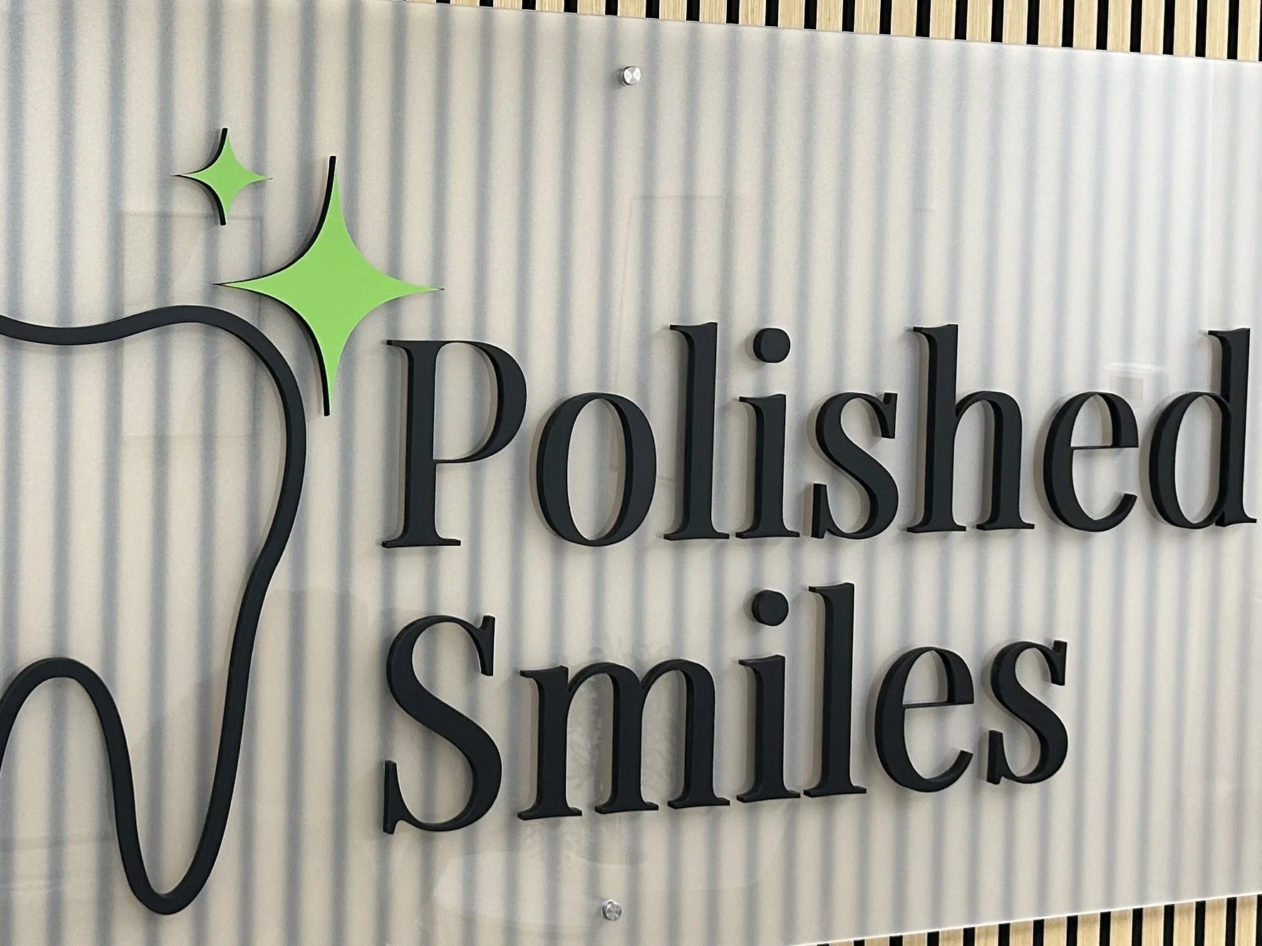 Sign reads 'Polished Smiles' with a stylized toothbrush and green sparkle design at the top left.