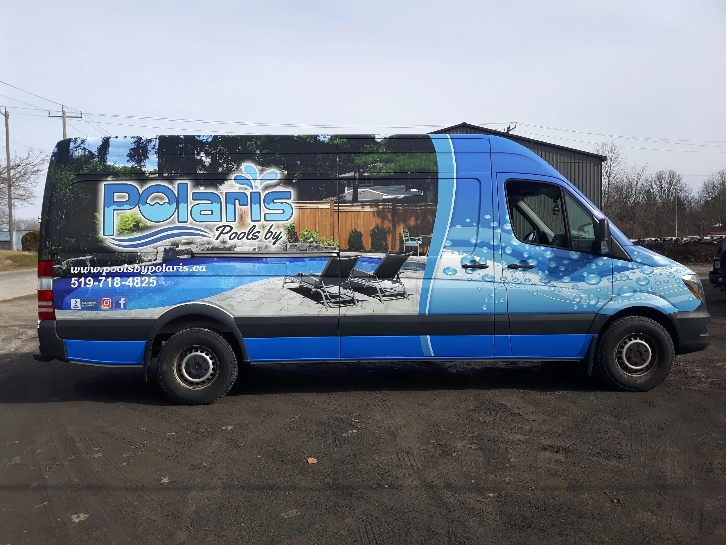Side view of a Polaris Pools service van with a poolside scene on the vehicle, including pool chairs, a swimming pool, water bubbles, and the company's contact information.