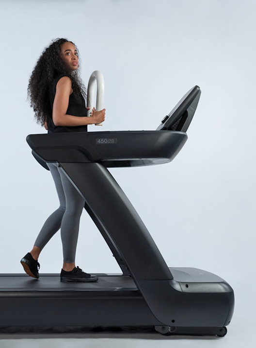 A woman walking on a treadmill.
