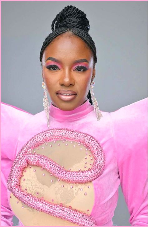 Eyeconic Beauty owner in pink dress.