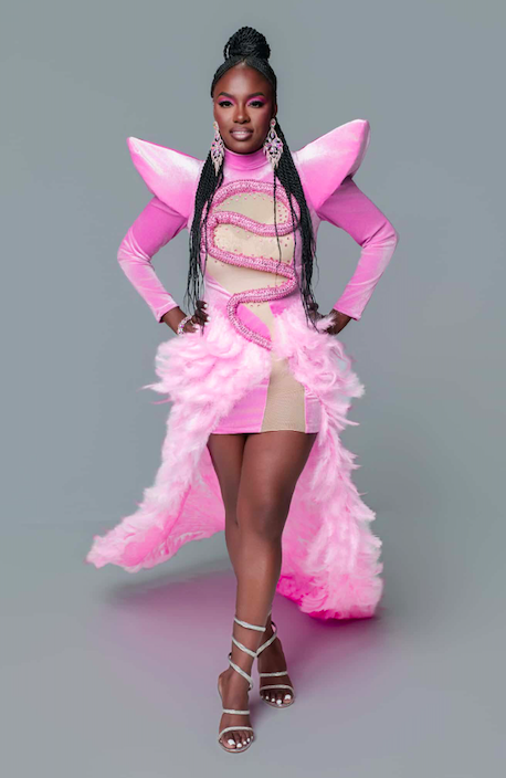 Eyeconic Beauty owner in pink dress.