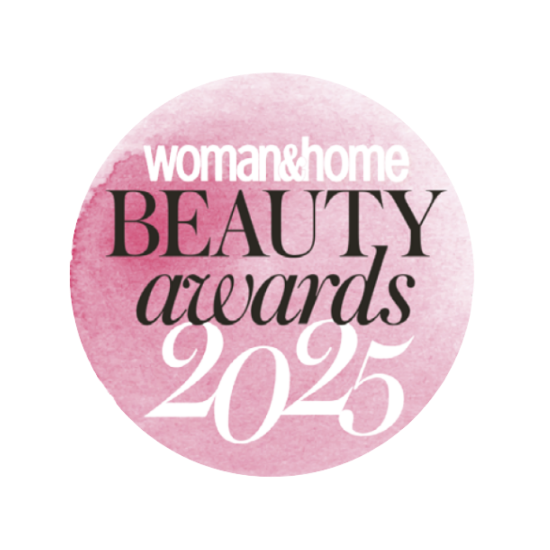 Pink circular badge with white and black text reading 'woman&home BEAUTY awards 2025'.