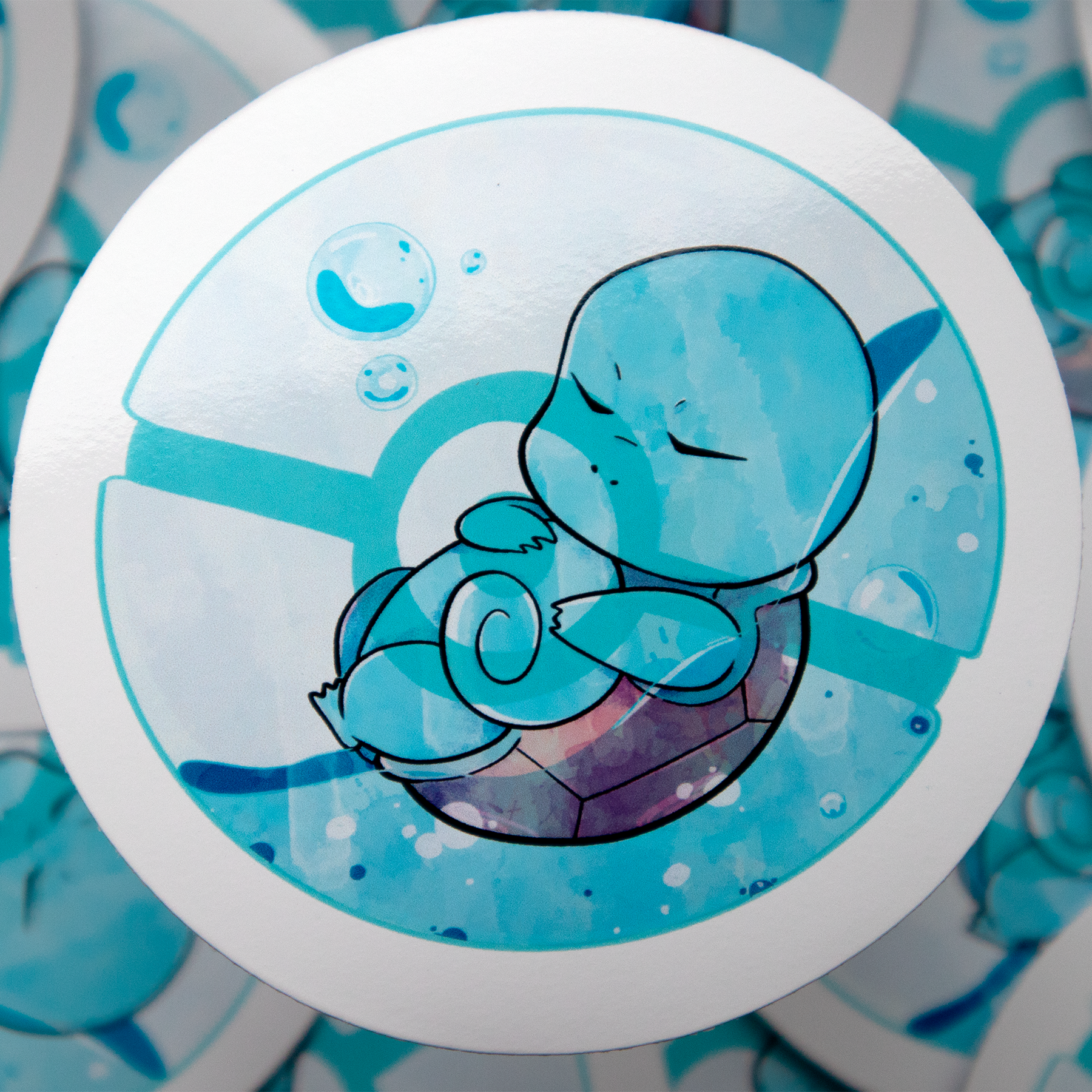 A cartoon illustration of 'Squirtle' from Pokémon, a blue turtle with a shell. It's eyes are closed, resting in water, surrounded by blue bubbles in a Pokeball.