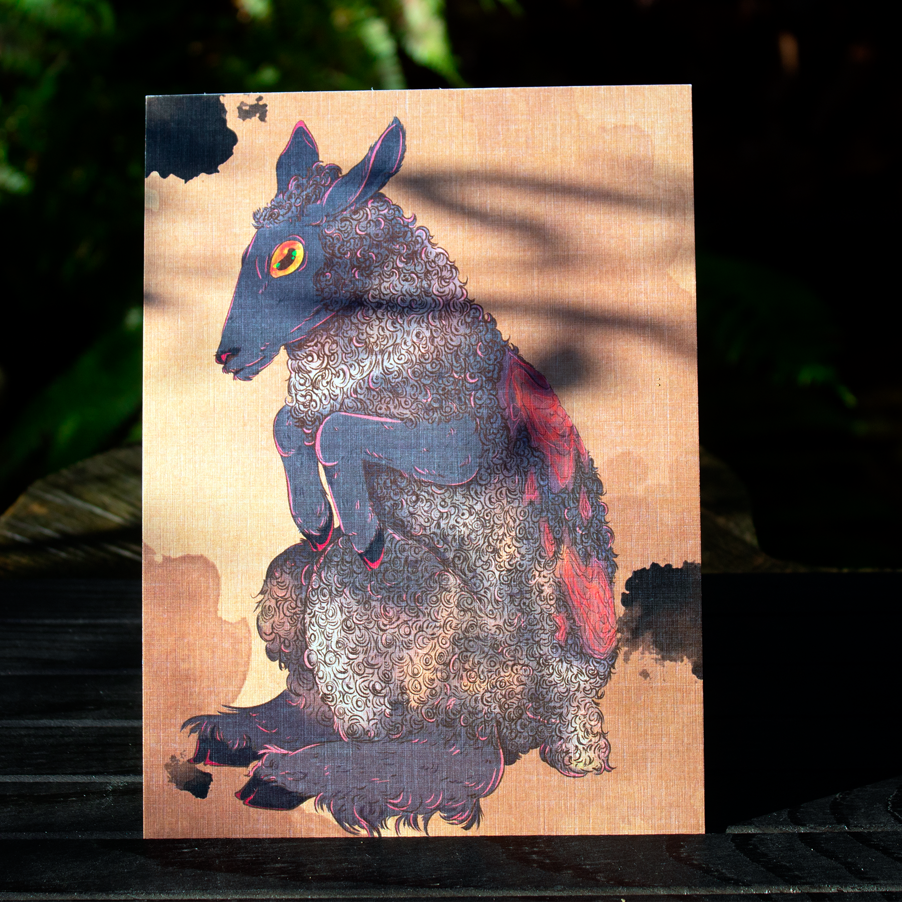 A colorful illustration of a sheep with a dark face and curly wool, featuring a humanoid stance and bright, stylized eyes.