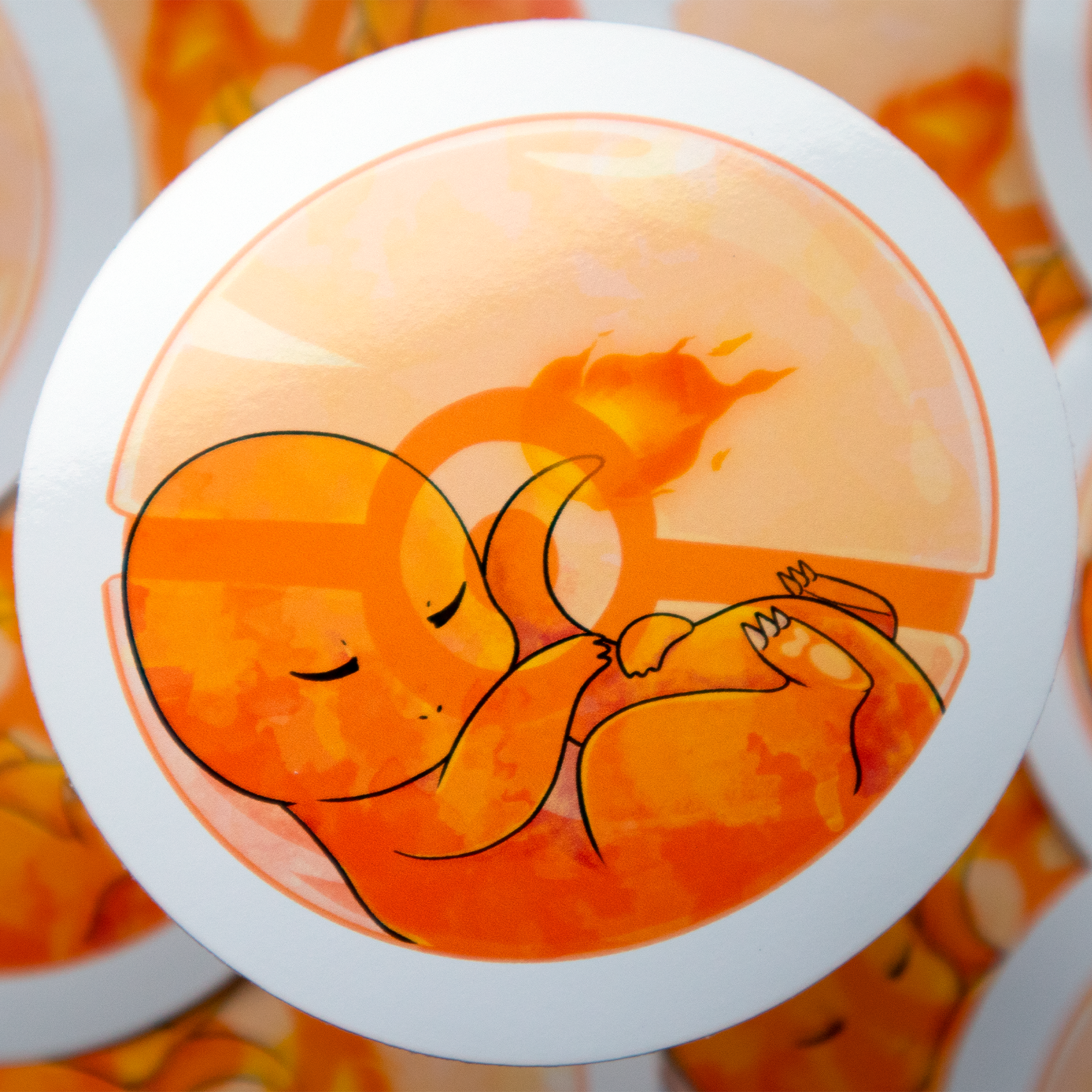 A cartoon illustration of 'Charmander' from Pokémon, an orange dinosaur with a fire tail. It's eyes are closed, surrounded by orange in a Pokeball.