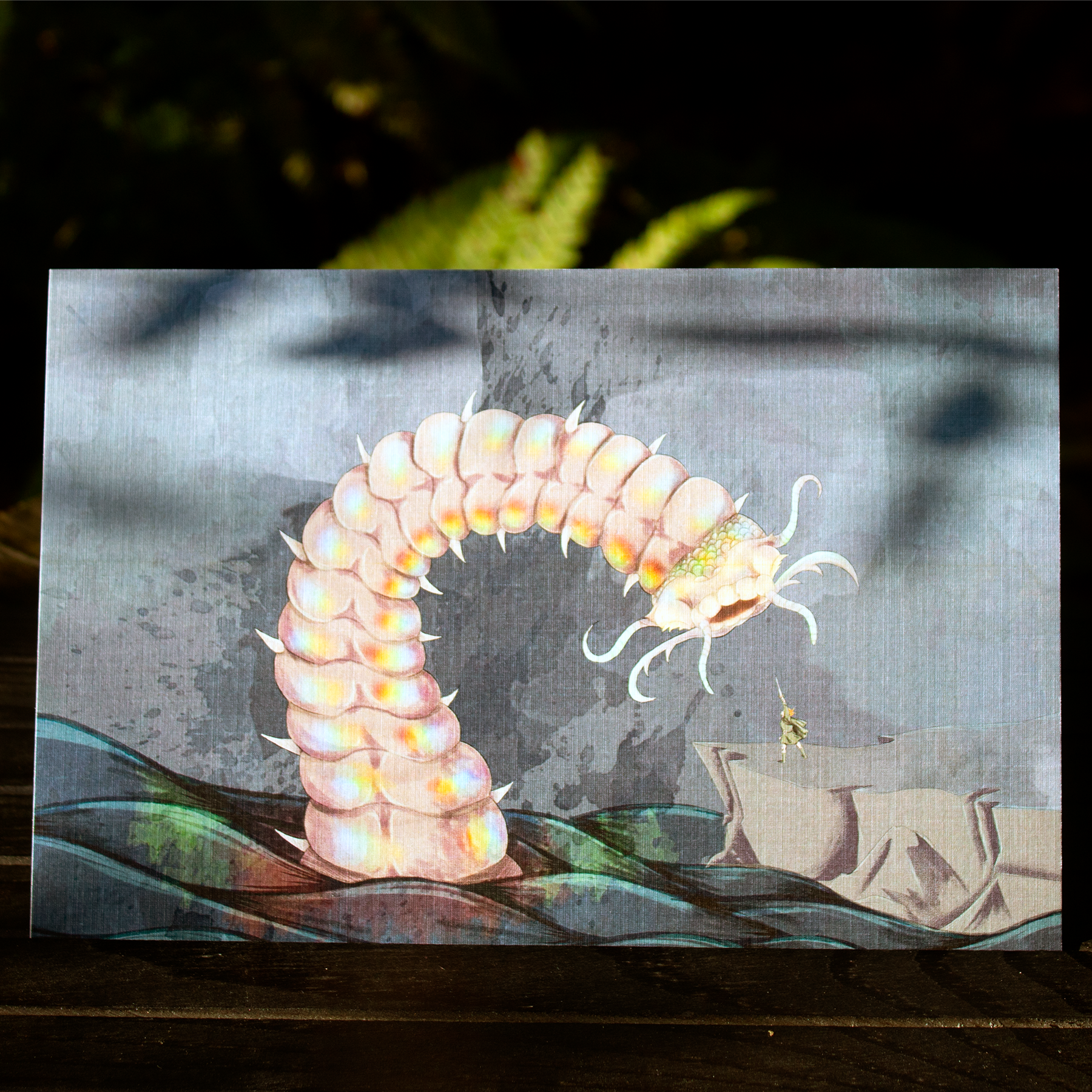 Illustration of a large, segmented bobbit worm creature with spikes and antennae, standing on a rocky surface, directed towards a tiny figure with a sword.