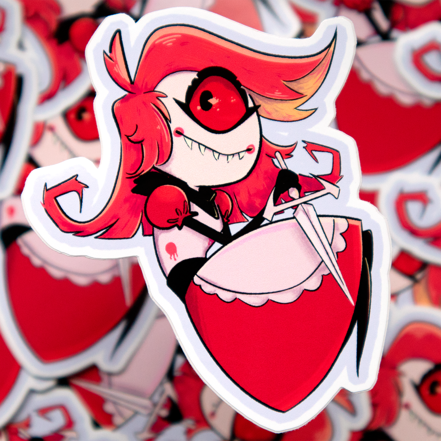 A cartoon sticker of a character with red hair, one big eye with sharp eye lashes, and sharp teeth. Wearing a red maids dress and holding a knife. The character Niffty from the 'Hazbin Hotel' animated show on Amazon Prime.
