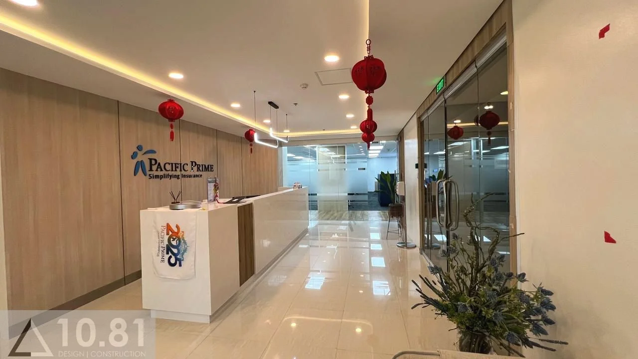 BPO office reception area with minimalist desk, festive ceiling decor, and glass-walled interiors.