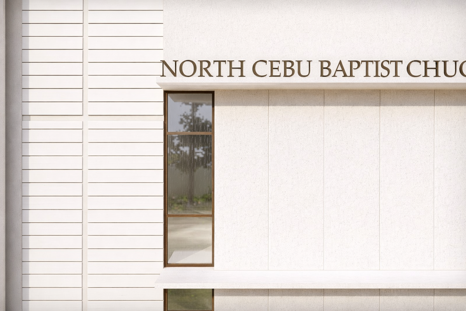 Close-up of North Cebu Baptist Church exterior wall with building name signage.