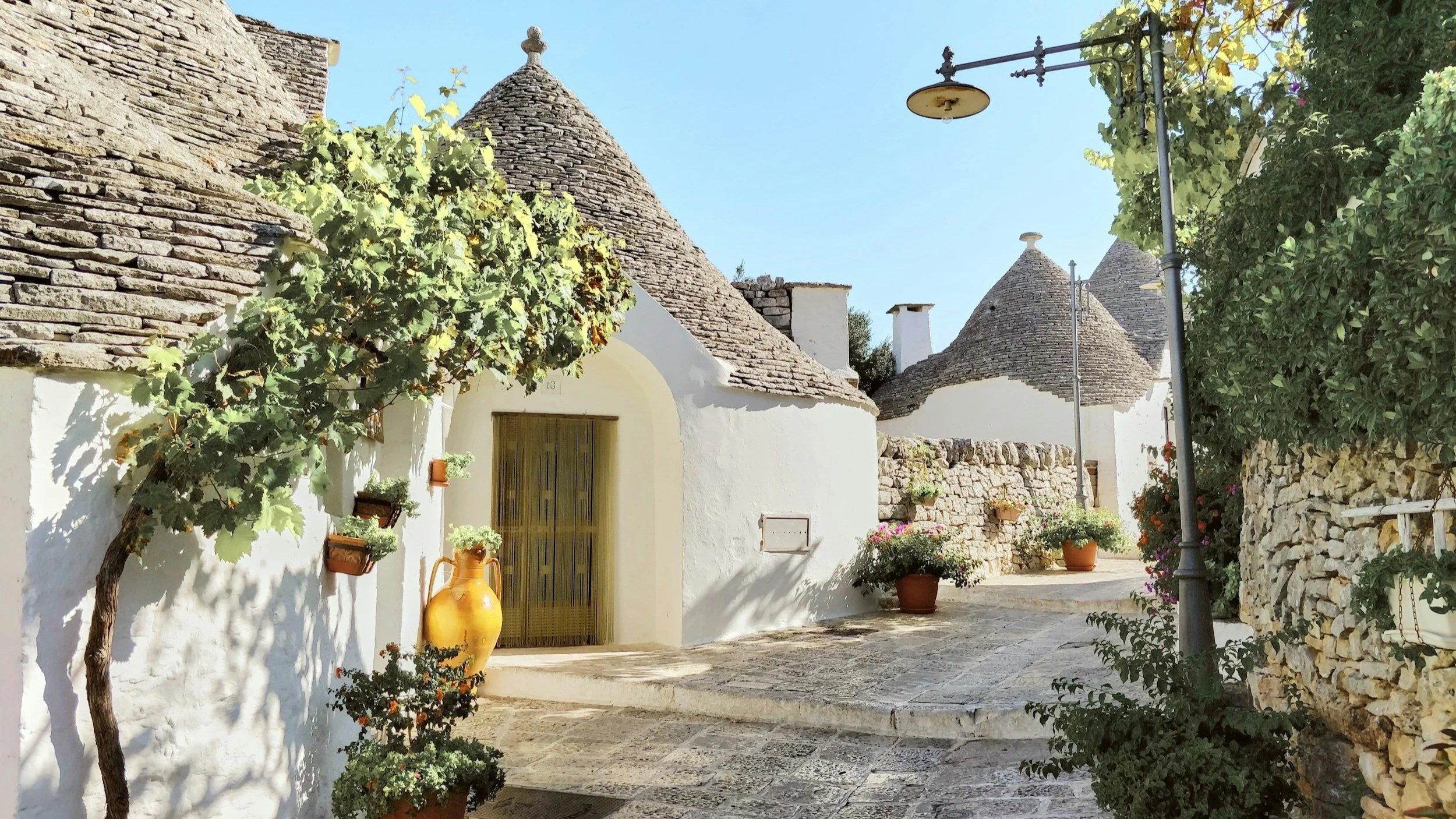 Trulli on a cobblestone street in Alberobello Italy.