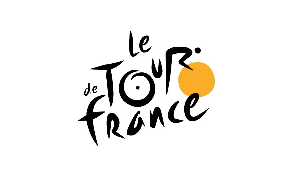 Stylized text reading "Le Tour de France" with an orange circle next to the text on a white background.