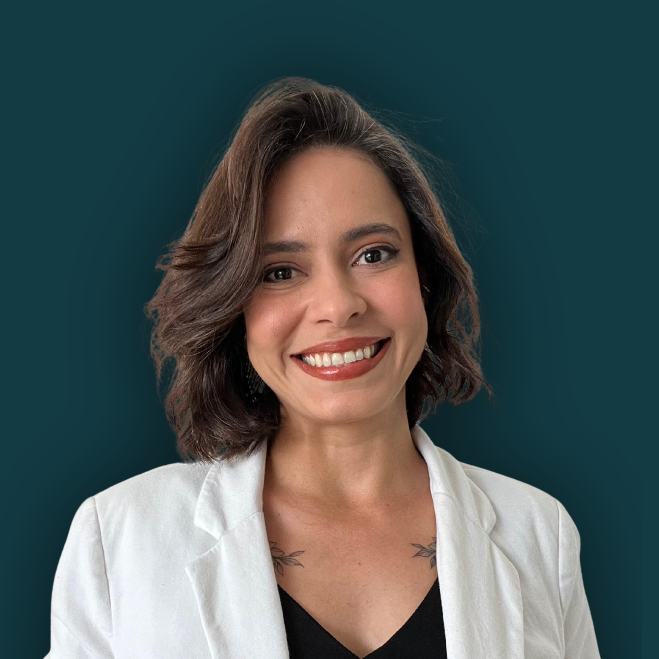 A smiling woman with shoulder-length brunette hair, wearing a white blazer over a black top, against a dark teal background.