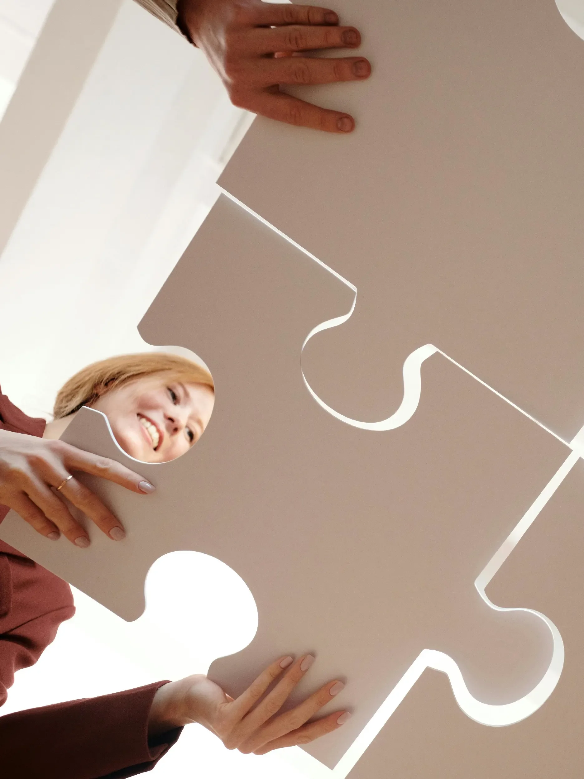 People putting large puzzle pieces together