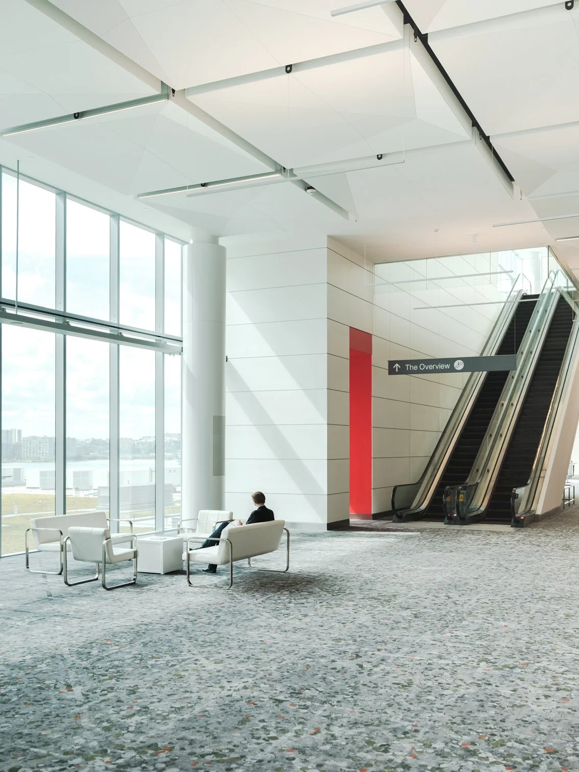 Public interior hallway at the Javits Center with floor-to-ceiling windows and natural light in New York City