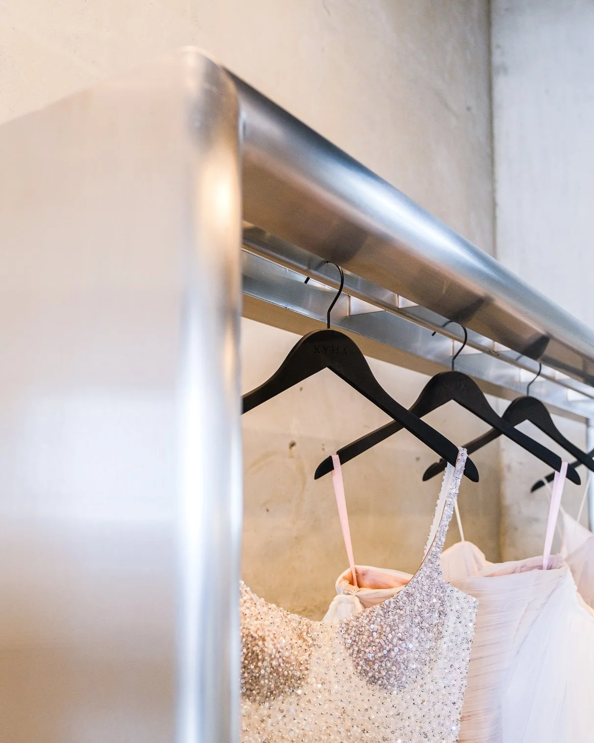 kyha bridal flagship showroom new york brushed metal garment rack