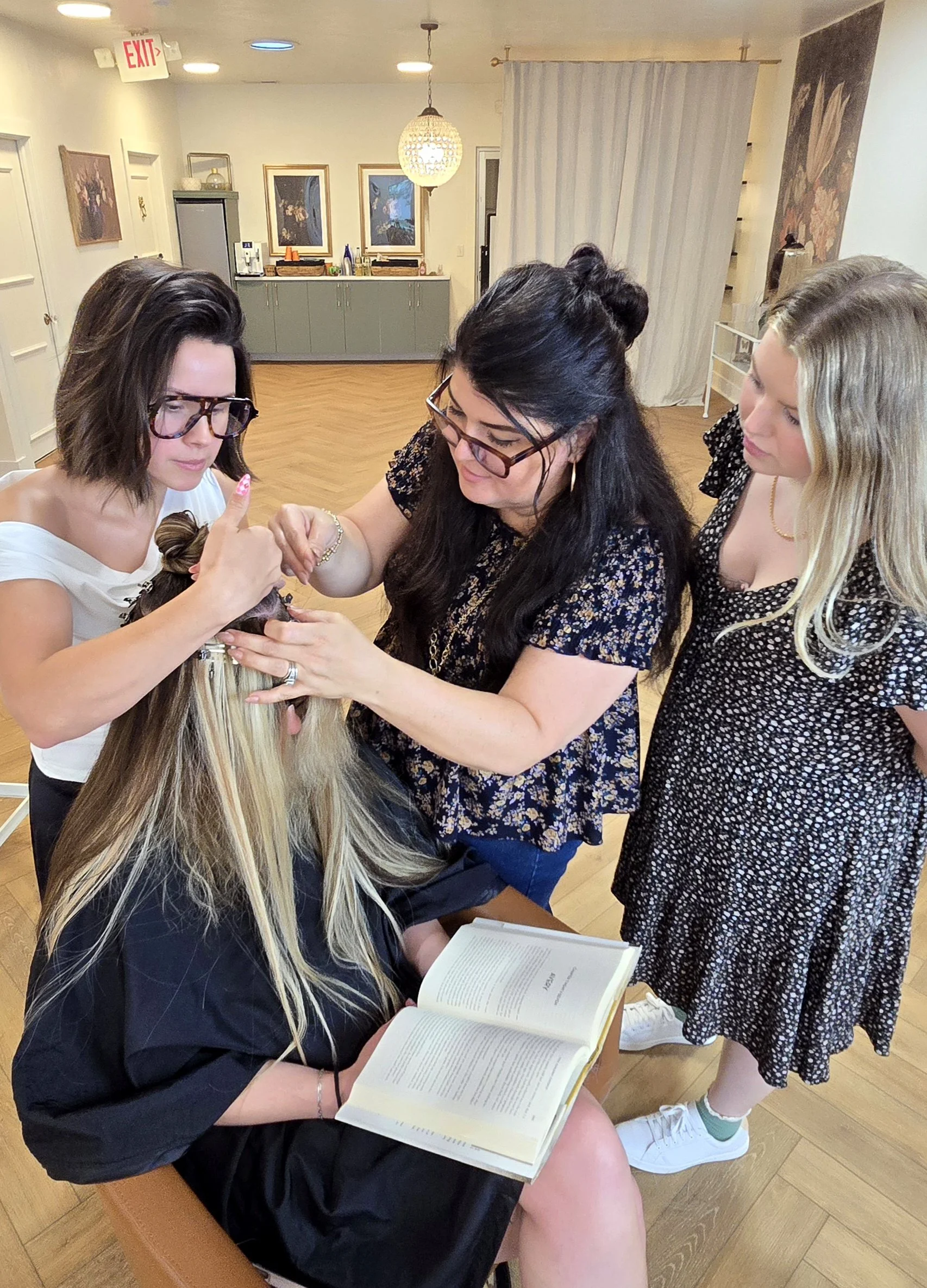 Professional hair stylist practicing the Luna Method beaded row technique during a hands-on certification class.