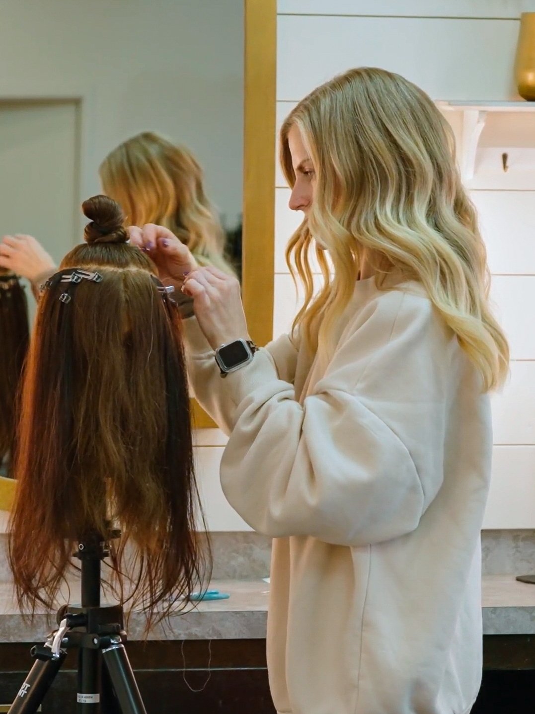 Close-up of seamless Luna Method hair extension tracks showing the discreet and flat-to-head application.