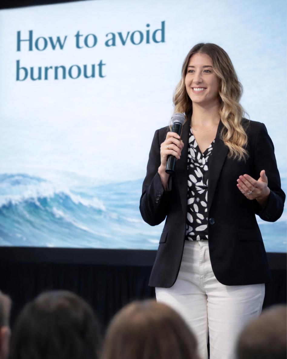 Mental health therapist, Jennifer Torres, giving a presentation titled 'How to avoid burnout' in front of a screen with ocean waves.
