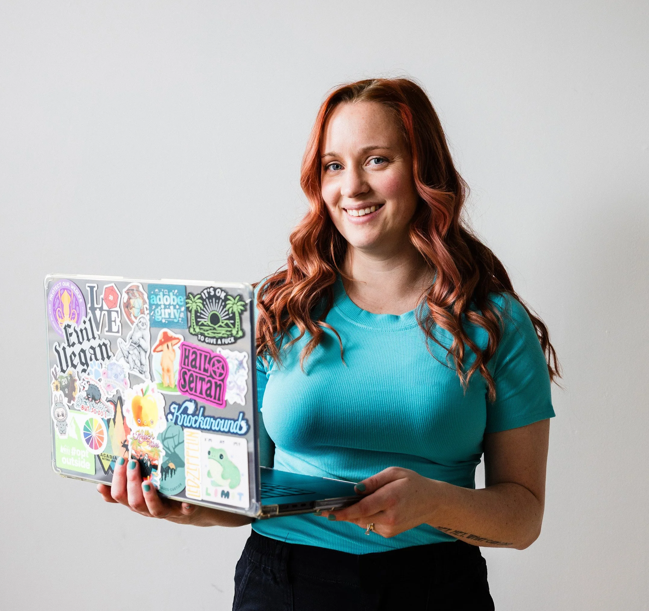 Kristen Mann holding her laptop and smiling