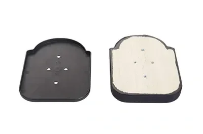 Two black plastic objects, one with a white cleaning pad attached