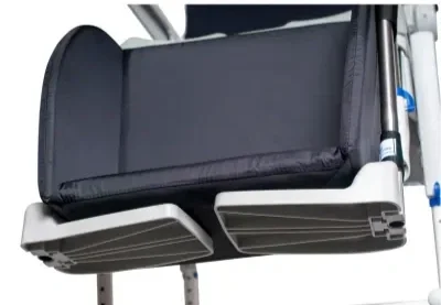 A black padded pad resting on a metallic surface, possibly part of medical or sports equipment.