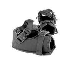 A black tactical bag with adjustable straps and multiple pockets, with a pair of black gloves resting on top.