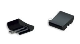 Two black electronic accessories or adapters, one open with internal components visible, and one closed