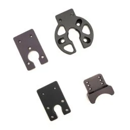 Four black metal parts with various shapes and cutouts, possibly for mechanical or industrial use.