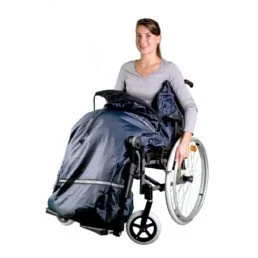 Woman in wheelchair with a large dark bag or backpack on her lap.
