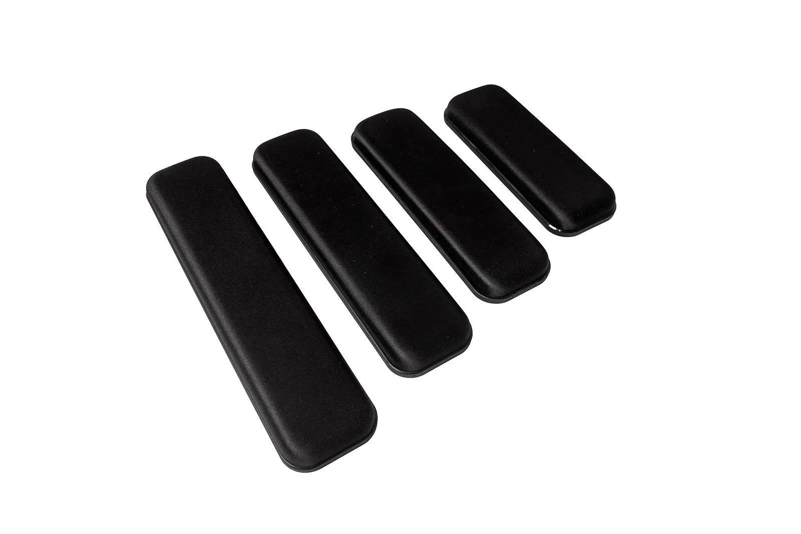 Set of four black keyboard key caps arranged diagonally on a white background.