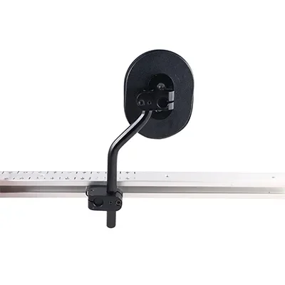 A mounted device on a rail, possibly a sensor or camera, with a black circular component and a metal arm, against a plain white background.