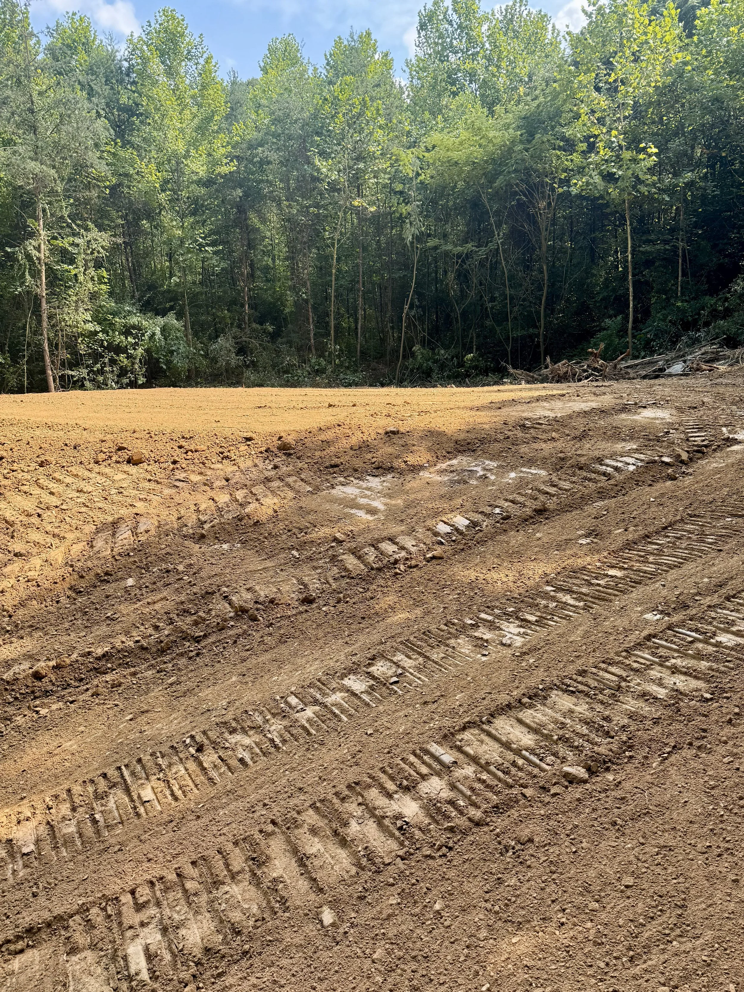 Clearing the overgrowth, widening and rebuilt an existing road for a customer; completing with newly pressed gravel.