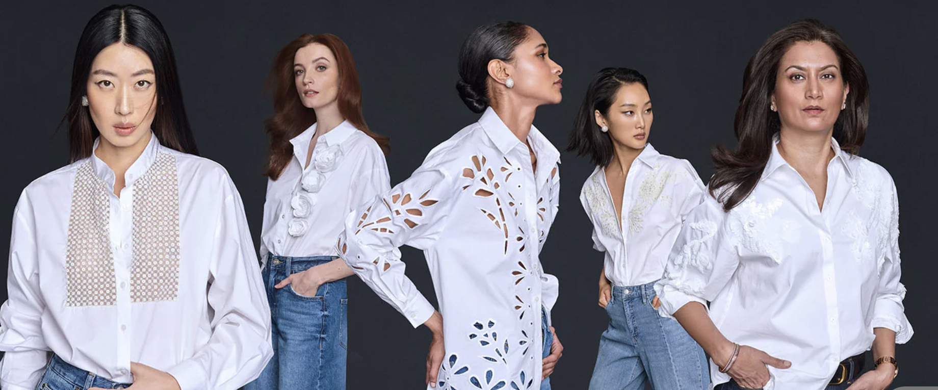 Five diverse women wearing white blouses and jeans, standing against a dark background, posing confidently with various expressions.