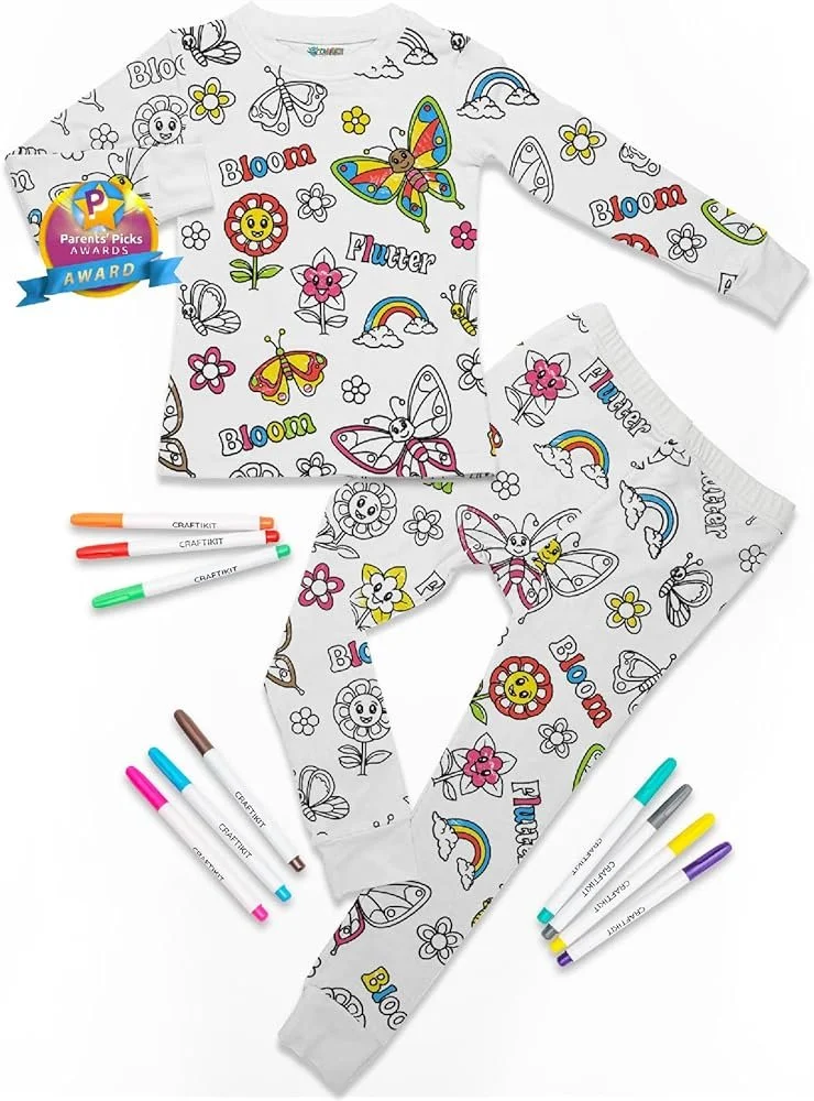 A children's pajama set with colorful cartoon butterflies, flowers, rainbows, clouds, and the words 'Bloom' and 'Flutter' on a white background, along with six colorful markers.