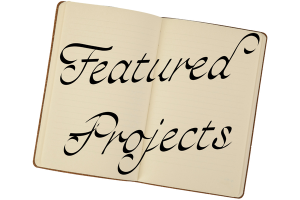 An open notebook with the words "Featured Projects" written in elegant black script.