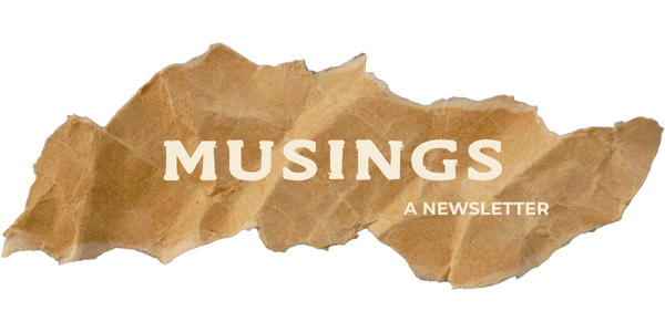 Torn brown paper with 'Musings' and 'A Newsletter' written on it.
