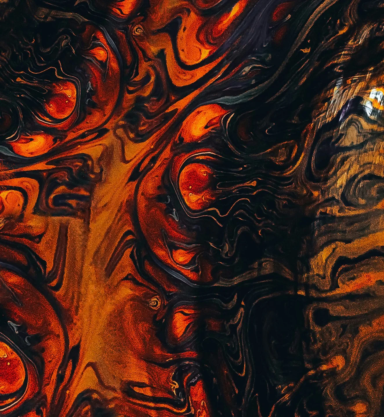 Abstract swirling pattern in shades of red, orange, black, and brown, resembling a marbled or fiery design.
