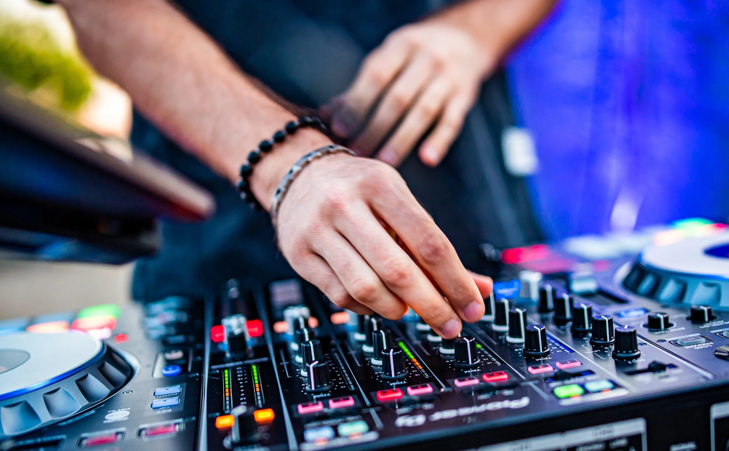 PoliMonitor DJ Hands creating and regulating music on dj console mixer for party conference