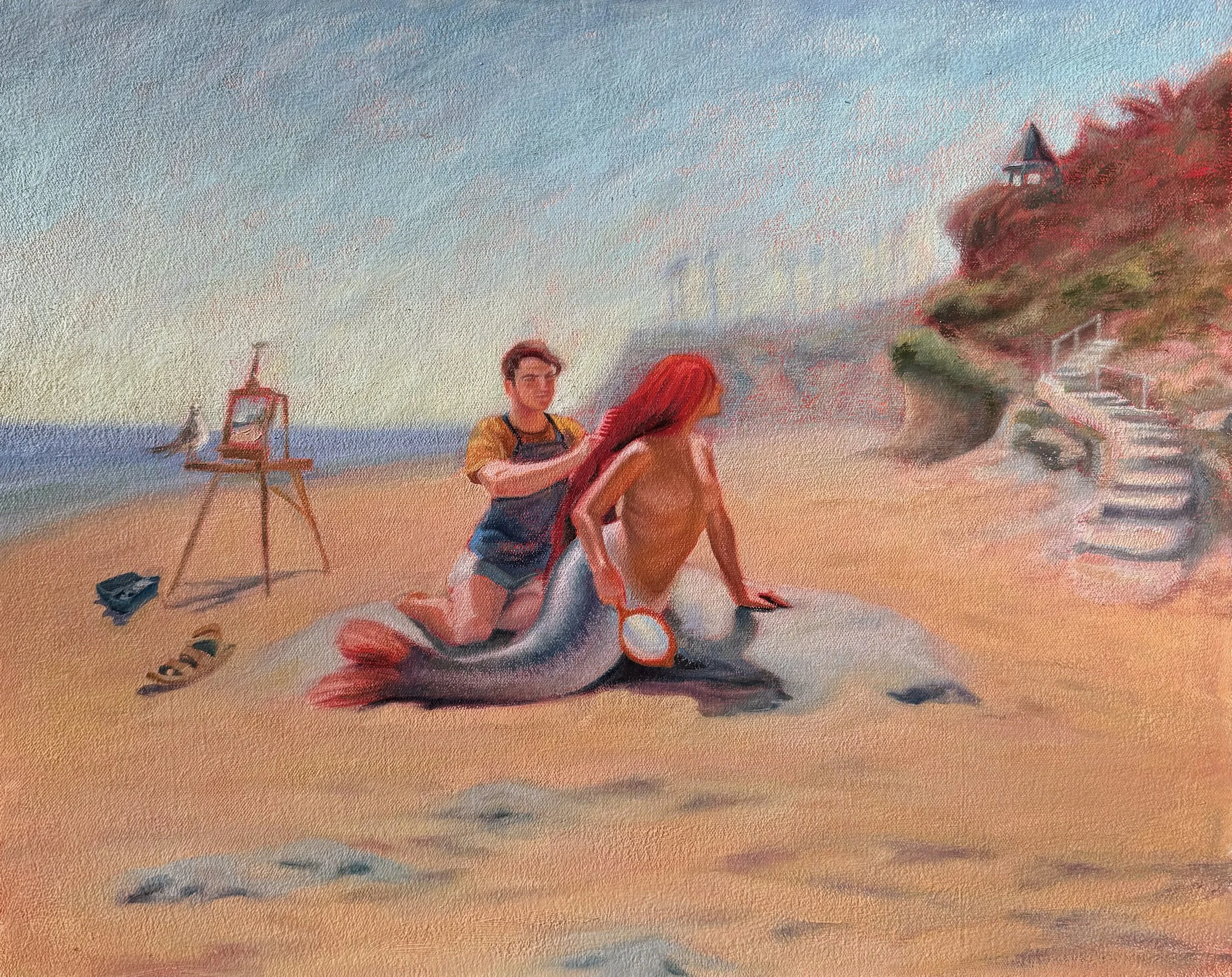 A young man painting a woman with a mermaid tail on the beach at sunset, with an easel and art supplies nearby and a staircase leading to houses on a hill.