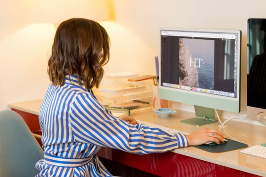 Travel agent Julie Ann Hargett, owner of H Luxury Travel, working at her computer
