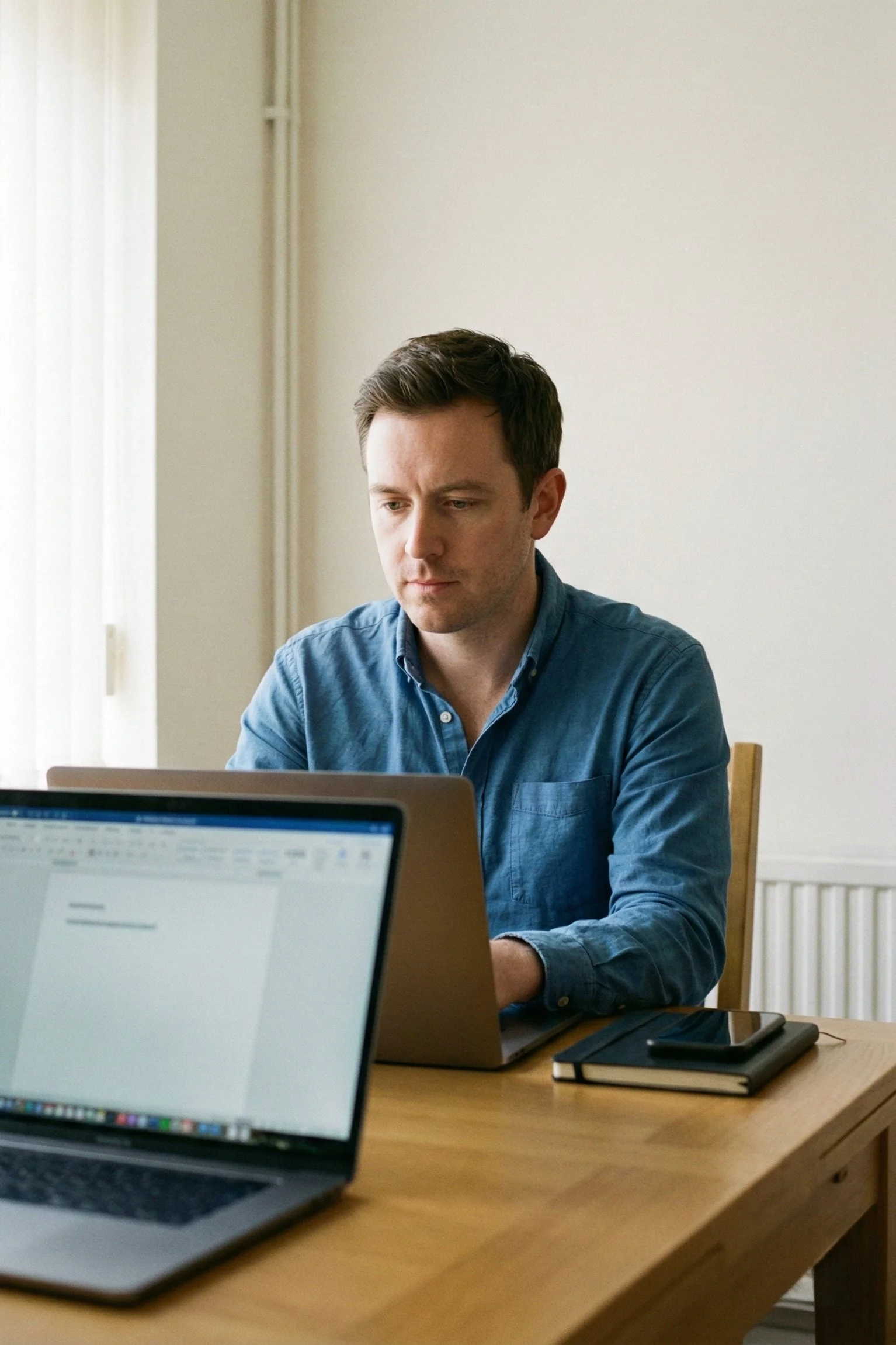 Employer submitting a social work vacancy on a laptop in a UK office