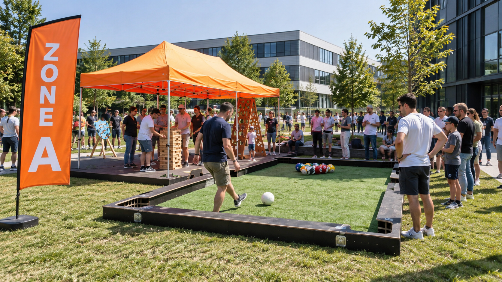 People playing an outdoor game similar to bocce or lawn bowling on a small artificial turf court, with a crowd watching, near a large orange tent with a sign that reads 'ONE A', and a large building with glass windows in the background on a sunny day.
