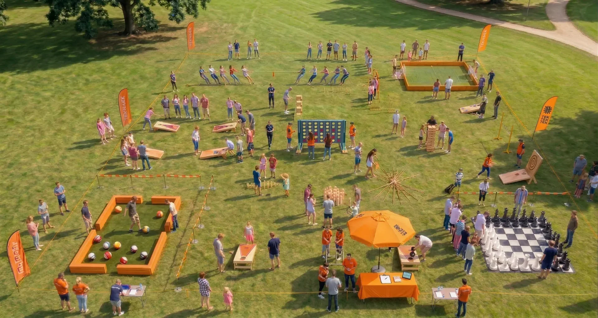 Grande zone d’activités TakTakTak avec plusieurs jeux géants et participants lors d’un festival ou événement extérieur.