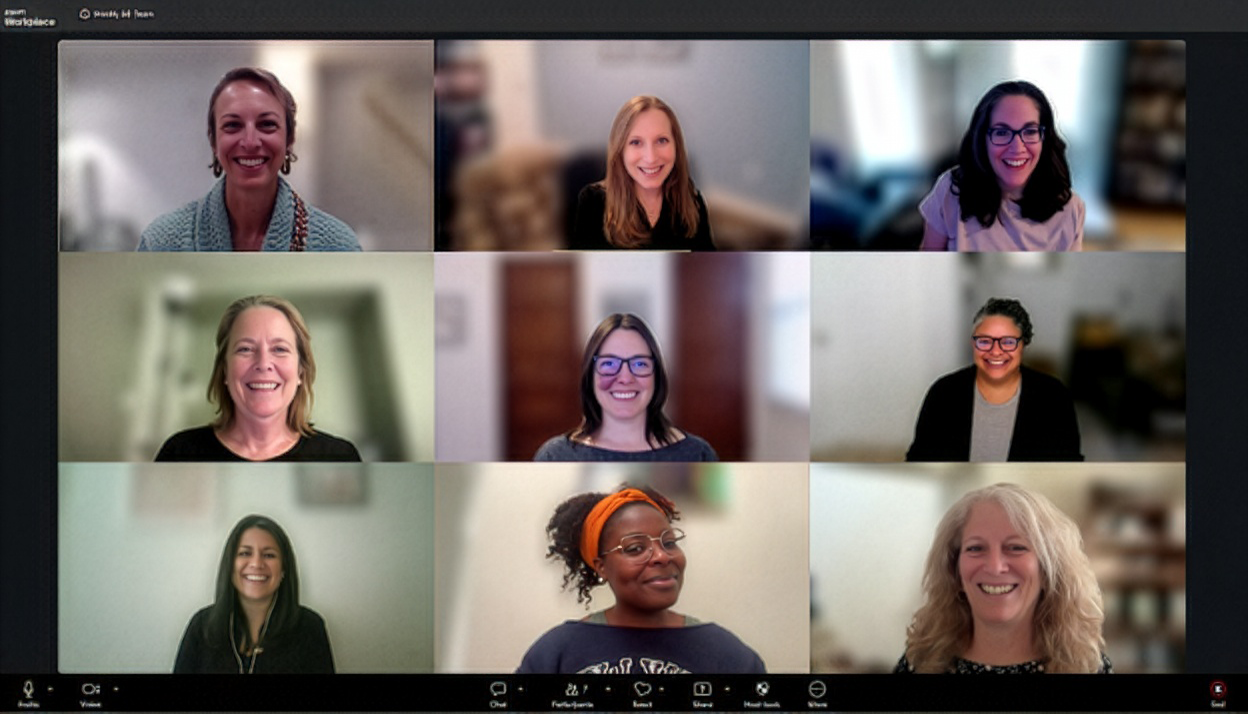 A screenshot of a video conference call showing nine diverse women smiling and looking at their cameras, arranged in a grid of three rows and three columns.