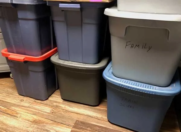 Rubbermaid type plastic tubs full of photos to organize