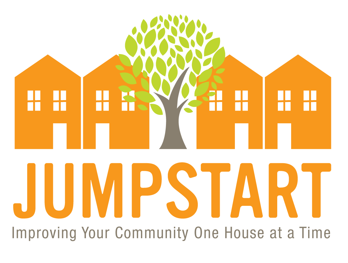 Logo for Jumpstart community housing program with orange houses and a green tree, with the text 'JUMPSTART' and the slogan 'Improving Your Community One House at a Time'.