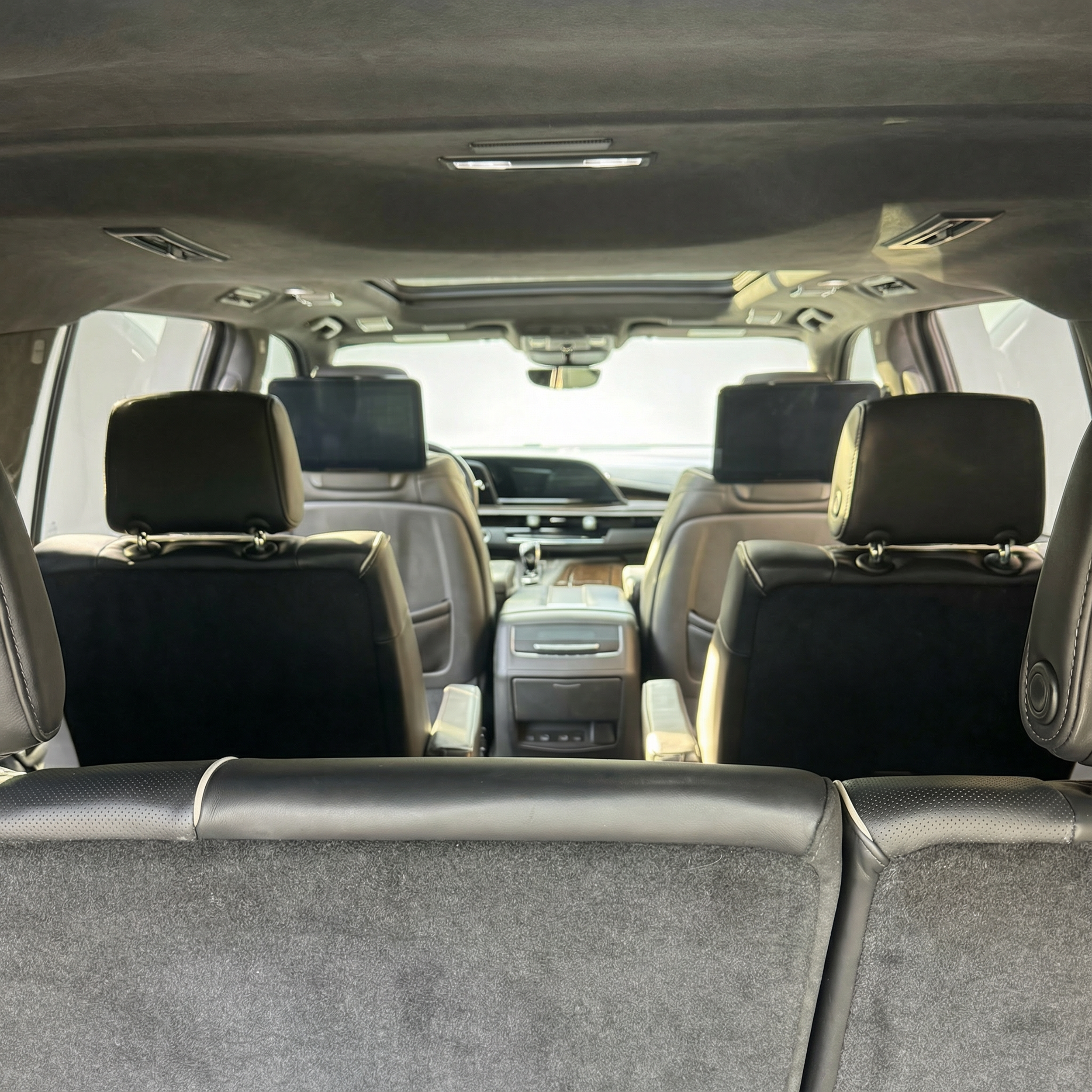 Interior view from the back seat of a 2021 black Cadillac Escalade ESV