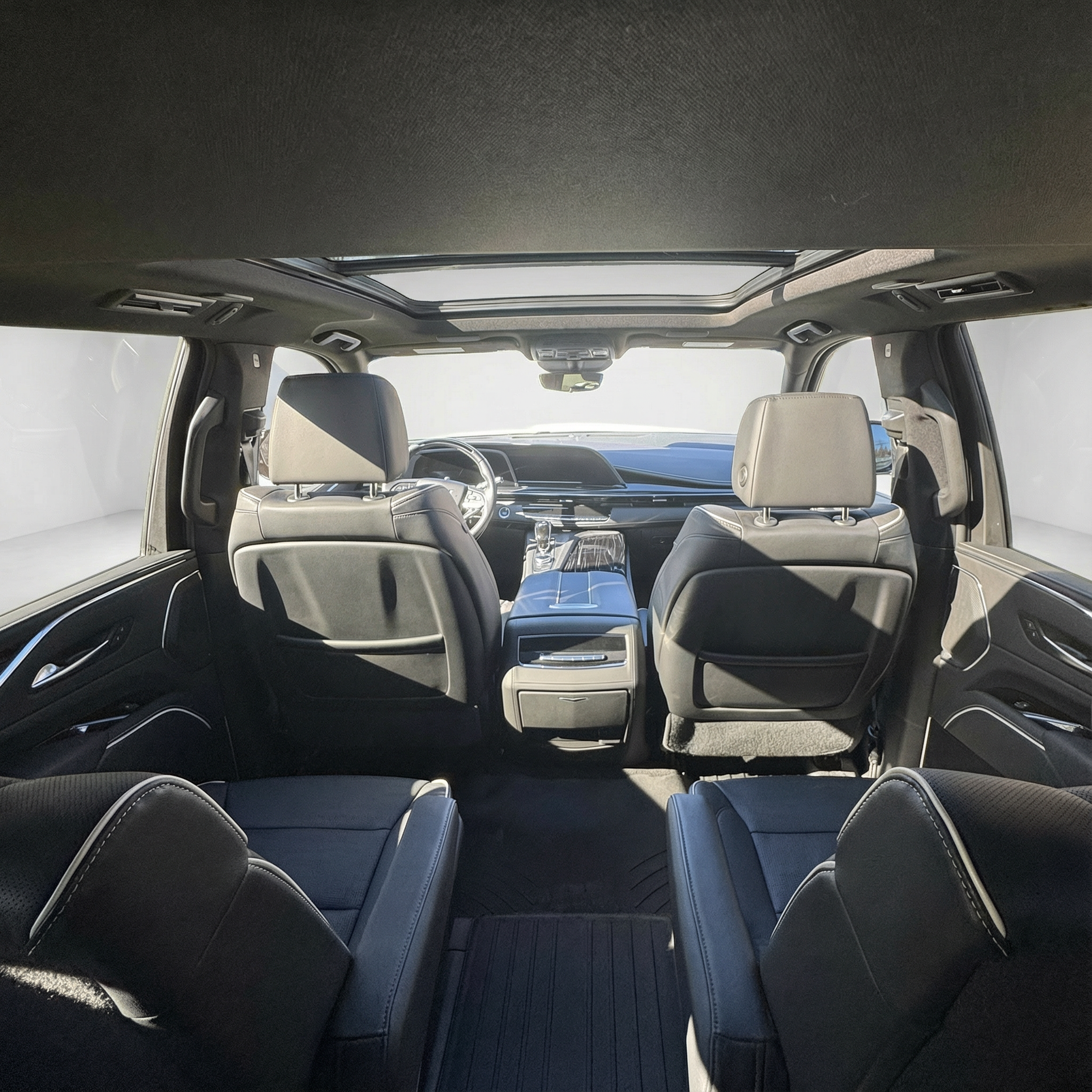 Interior view from the back seat of a 2023 black Cadillac Escalade Sport