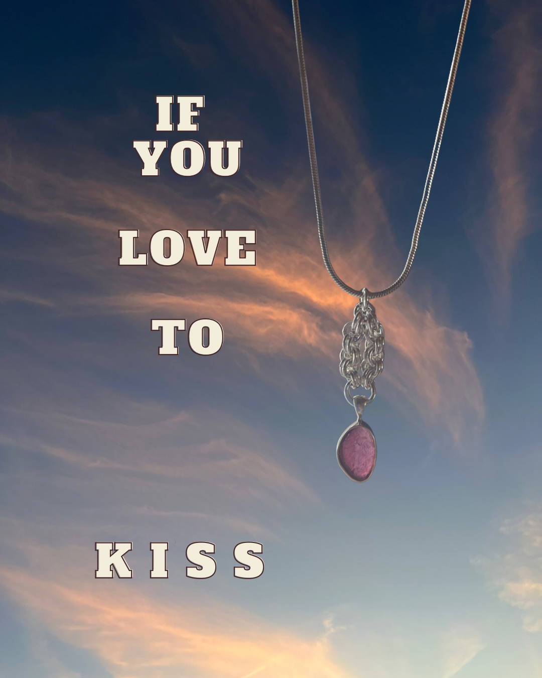 A silver necklace with a pink stone pendant against a sky with clouds and a colorful sunset. The text on the image says, "If you love to kiss."