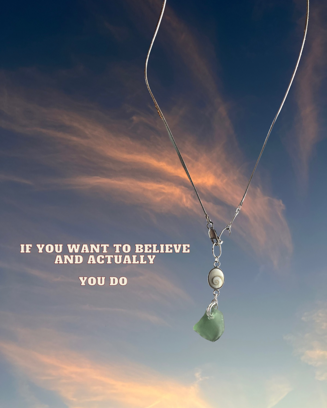 A necklace with a shell and a green stone hangs against a sky with pink and blue clouds, with the quote 'If you want to believe and actually you do' in pink text.